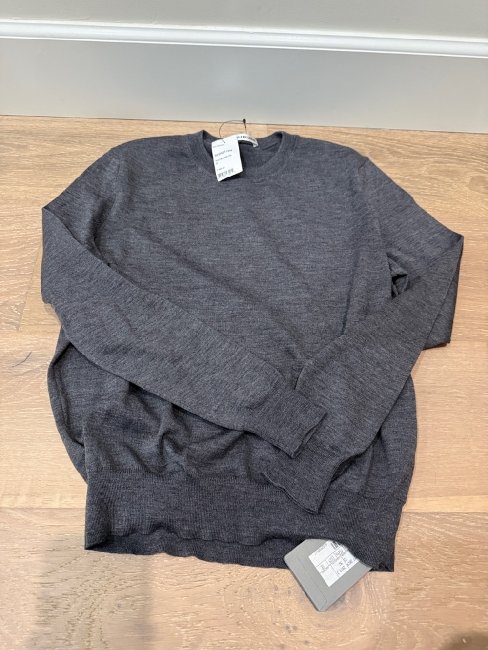 Brand new authentic Sweater in Charcoal Gray. Pls note small hole on sleeve.